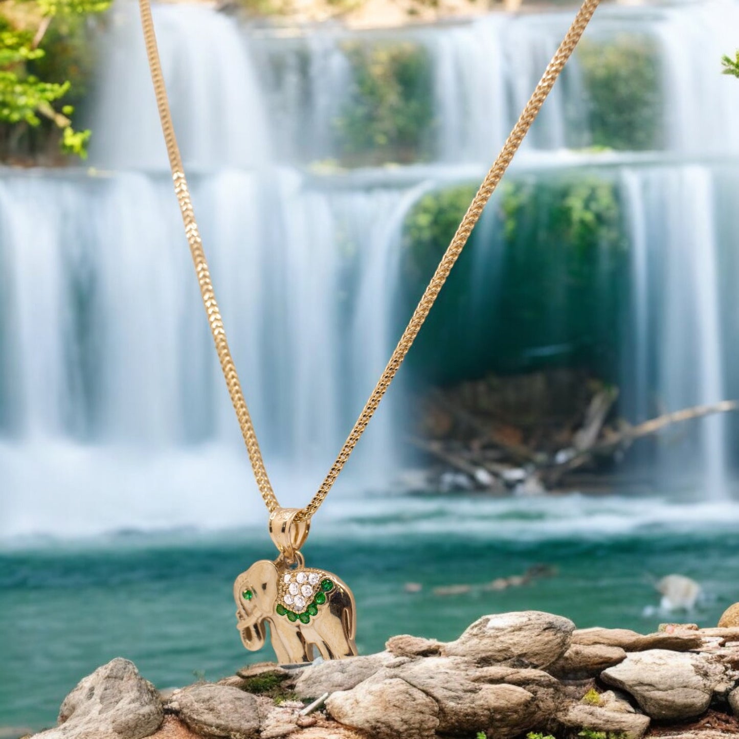 Majestic elephant pendant with green stones paired with a necklace