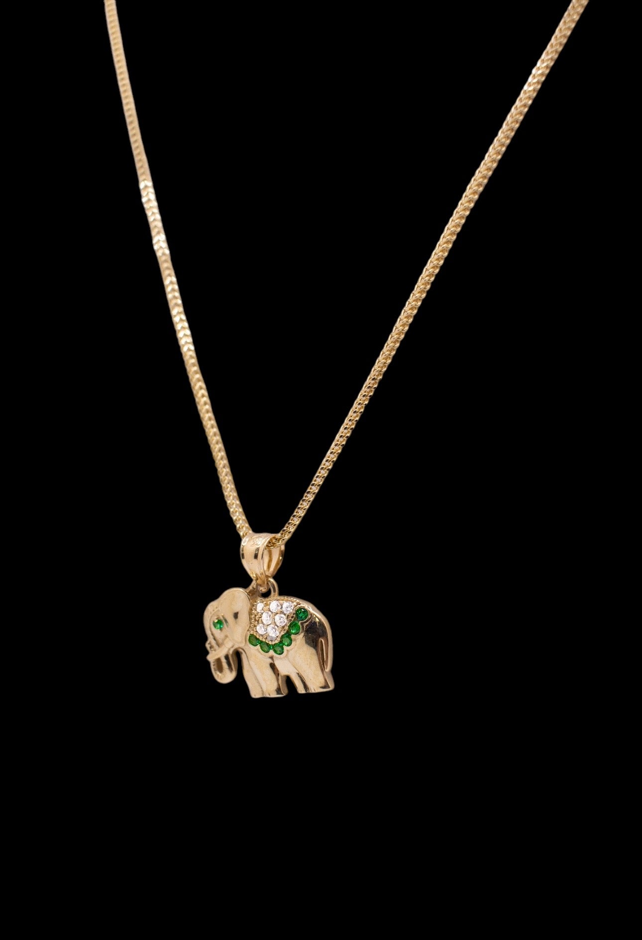 Majestic elephant pendant with green stones paired with a necklace